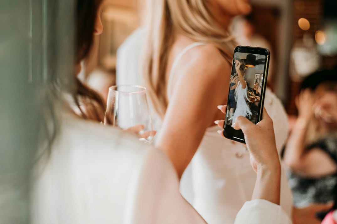 Woman taking photo at wedding